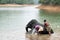 Bathing time for elephant in a lake with gadman