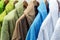 Bathrobes of different colors hang on a hanger