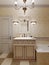 Bathroom in art deco style, beige tiles on the walls with ornament. Bath, washbasin and toilet