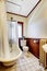 Bathroom with bath tub white wraparound curtain