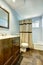 Bathroom with brown tile floor and light blue walls