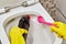 Bathroom cleaning by a professional cleaner. Rubber gloves for cleaning.