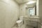 Bathroom decorated with cream colored faux marble tiles