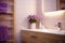 Bathroom design. The bathroom is lined with purple tiles. The room has a wooden cabinet, an illuminated mirror and a