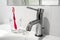 Bathroom faucet and wash basin with water glass and toothbrush