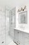 Bathroom with grey vanity and white granite.