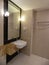 bathroom, haven of tranquility, embraced me with its pristine tiles and soft ambient lighting.The gleaming fixtures and immaculate