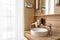 Bathroom in hotel room with window, sink, faucet, hair dryer and mirror