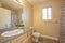 Bathroom interior with close up of sink cabinet and mirror beside the toilet