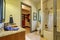 Bathroom interior in olive tones with walk-in closet.