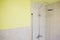 Bathroom interior shower rain head yellow neutral wall tiles home house
