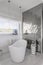 Bathroom interior with trendy grey design with white furniture