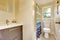 Bathroom interior with vanity cabinet and colorful shower curtain.