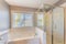 Bathroom interior with a view of a fenced yard from the window with blinds