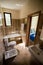 Bathroom interior - washbasin, bidet, toilet, large mirror. The walls are light brown in color.