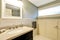 Bathroom interior in white and blue tones with black vanity cabinet.