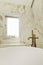 Bathroom with large bathtub with brass faucets and marble tiles with aluminum window