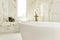 Bathroom with large bathtub with brass taps and marble tiles with aluminum window and recessed seat in the same material