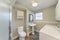 Bathroom and laundry room with shower stall and wall cabinets