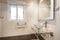 Bathroom with mirror with gray metal frame, glass washbasin