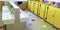 Bathroom of a nursery with white sinks and yellow toilet doors