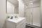 bathroom with one-piece white porcelain sink on lacquered wood