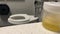 Bathroom pan to revieal it\\\'s a hospital bathroom with a fresh urine sample on the sink.