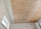 Bathroom renovation: Installing PVC ceiling cladding, plastic ceiling panels over a vapor barrier membrane and planked wood