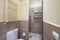 Bathroom with shower cabin with glass partition, white towel radiator, small white tiled