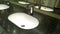 Bathroom sinks and touchless taps in public toilet and restroom. Modern faucet. Virus protection concept. Sanitary rules and requi