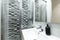 Bathroom with stainless steel and glass shower cabin, white