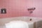 Bathroom tub with pink tile wall