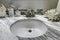 Bathroom vanity cabinet with white granite top. Sink and decorated corals