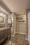 Bathroom with vanity facing the bathtub and shower behind the white curtain