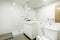 Bathroom with wall-to-wall mirror, glass-enclosed shower stall,