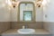 Bathroom with washbasin, mirror, lamps. European hotel design. Close-up.
