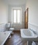 Bathroom with white walls and large black bathtub