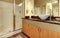 Bathroom with wood modern cabinets and white sink.