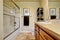 Bathroom wtih wooden vanity cabinet screened tub