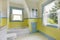 Bathroom with yellow walls, white tile floor, and full bath.
