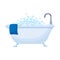 Bathtub full of soap foam bubbles with  blue towel