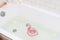 Bathtub with Plumerria Flowers and Inflatable Flamingo Toy Ring with Drink Bamboo Face Brush Home SPA Concept Relax