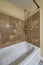 Bathtub with wall mounted handheld shower head and faucet