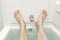 Bathtub With Water Running and Manâ€™s Feet