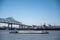 Baton Rouge, Louisiana, USA - 11.2022 - Barge crossing under the Horace Wilkinson Bridge with long lines of backed up