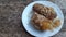 Battered and deep - fried unripe rice and grated coconut banana rolls recipe.