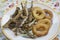 Battered and fried rings of squid and anchovies
