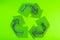 Batteries in the form of recycling on a green background. Battery recycling, environmental concept