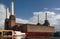 Battersea power station with one of iconic four white chimneys being fixed on a sunny day.