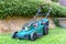Battery electric lawn mowers in the garden